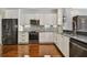 Modern kitchen with white cabinets, stainless steel appliances and granite countertops at 348 Larboard Way, Clearwater, FL 33767