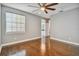 Spacious bedroom with hardwood floors, ceiling fan, and access to bathroom at 348 Larboard Way, Clearwater, FL 33767