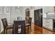 Modern kitchen with glass table, dark chairs, stainless steel appliances and hardwood floors at 348 Larboard Way, Clearwater, FL 33767