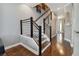 Modern staircase with metal railing and hardwood floors at 348 Larboard Way, Clearwater, FL 33767