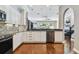 Modern kitchen with white cabinets, stainless steel appliances and hardwood floors at 348 Larboard Way, Clearwater, FL 33767
