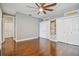 Bedroom with hardwood floors, ceiling fan and double closets at 348 Larboard Way, Clearwater, FL 33767