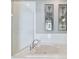 Bathroom with soaking tub, white tile, and decorative mirrors at 348 Larboard Way, Clearwater, FL 33767