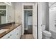 Modern bathroom with double vanity, dark countertop, and a separate shower and tub at 348 Larboard Way, Clearwater, FL 33767