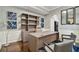 Spacious home office with built-in shelving and hardwood floors at 348 Larboard Way, Clearwater, FL 33767