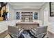 Modern home office with large desk, built-in shelving, and hardwood floors at 348 Larboard Way, Clearwater, FL 33767
