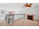 Spacious loft area with fireplace and balcony overlooking living area at 2725 Via Cipriani # 715B, Clearwater, FL 33764