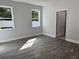 Spacious bedroom featuring wood-look floors and an ensuite bathroom at 37581 Teri Ct, Dade City, FL 33525