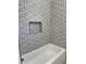 Clean bathroom with patterned tile and a bathtub at 37570 Teri Ct, Dade City, FL 33525