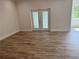 Living room with wood-look floors and french doors at 37570 Teri Ct, Dade City, FL 33525