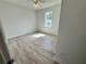 Simple bedroom with wood-look floors and a window at 37570 Teri Ct, Dade City, FL 33525
