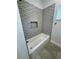 Stylish bathroom, featuring patterned tile and a bathtub at 37570 Teri Ct, Dade City, FL 33525