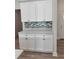 White kitchen cabinets and quartz countertops with a view of the dining area at 37570 Teri Ct, Dade City, FL 33525