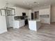 Open concept kitchen with white cabinets and a large island at 37570 Teri Ct, Dade City, FL 33525