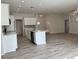 Modern kitchen with white cabinets and an island at 37570 Teri Ct, Dade City, FL 33525