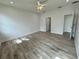 Bright bedroom with wood-look floors and ceiling fan at 37570 Teri Ct, Dade City, FL 33525
