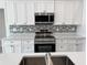 Modern kitchen featuring stainless steel appliances and a stylish backsplash at 37570 Teri Ct, Dade City, FL 33525