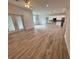 Open living room and kitchen with wood-look floors at 37570 Teri Ct, Dade City, FL 33525