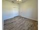 Light and airy bedroom with wood-look floors and double door closet at 37570 Teri Ct, Dade City, FL 33525