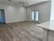 Spacious living room with wood-look floors and French doors leading outside at 37570 Teri Ct, Dade City, FL 33525