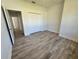 Spacious bedroom featuring wood-look floors and a double door closet at 37570 Teri Ct, Dade City, FL 33525