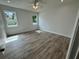 Spacious bedroom featuring wood-look floors and natural light at 37570 Teri Ct, Dade City, FL 33525