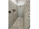 Walk-in shower with patterned tile and pebble floor at 37570 Teri Ct, Dade City, FL 33525