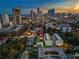 Aerial shot pinpointing a property with a unique rooftop deck and views of the city skyline at dusk at 103 5Th N Ave, St Petersburg, FL 33701