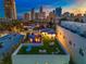 Aerial view of property with a rooftop deck, mural, and surrounding city skyline at sunset at 103 5Th N Ave, St Petersburg, FL 33701