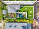 Bird's eye view of a modern home with a rooftop deck, a pool, and lush landscaping at 103 5Th N Ave, St Petersburg, FL 33701