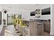 Open bar area with counter seating, mounted TVs, and a view of the outdoor living area at 103 5Th N Ave, St Petersburg, FL 33701