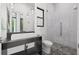 Modern bathroom featuring a stylish vanity, tiled shower, and geometric-patterned floor at 103 5Th N Ave, St Petersburg, FL 33701