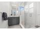 Stylish bathroom with a glass-enclosed shower, gray vanity, and marble countertop at 103 5Th N Ave, St Petersburg, FL 33701