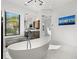 Luxurious bathroom featuring a freestanding tub, sleek vanity, and a modern, frameless glass shower at 103 5Th N Ave, St Petersburg, FL 33701