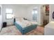 Cozy bedroom with a colorful rug, platform bed, and walk-in closet at 103 5Th N Ave, St Petersburg, FL 33701
