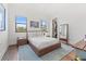 Modern bedroom featuring hardwood floors, two windows, and a spacious closet at 103 5Th N Ave, St Petersburg, FL 33701