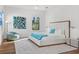 Modern bedroom with textured wall, ample natural light, contemporary art and luxurious white bed at 103 5Th N Ave, St Petersburg, FL 33701