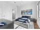 Modern bedroom boasts a gray platform bed, unique artwork, and light-filled atmosphere at 103 5Th N Ave, St Petersburg, FL 33701