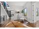 Bright entryway featuring wood floors, staircase, and stylish decor, creating a welcoming and modern ambiance at 103 5Th N Ave, St Petersburg, FL 33701