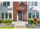 Close up of a modern home with a wood facade, black door, and landscaped front yard at 103 5Th N Ave, St Petersburg, FL 33701