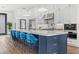 Bright kitchen features stainless steel appliances, marble countertops, white cabinetry, and blue barstools at 103 5Th N Ave, St Petersburg, FL 33701