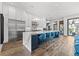 Beautiful kitchen with a large waterfall island, stainless steel appliances, white cabinets, and blue barstools at 103 5Th N Ave, St Petersburg, FL 33701