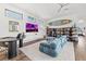 Open concept living room featuring a long blue sofa, hardwood floors, and a surfboard wall decoration at 103 5Th N Ave, St Petersburg, FL 33701