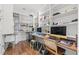 Bright office area featuring built-in shelving and two desks with multiple monitors at 103 5Th N Ave, St Petersburg, FL 33701