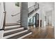 Elegant staircase featuring hardwood steps, modern railings, and a wine cellar at 103 5Th N Ave, St Petersburg, FL 33701