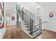 Modern staircase with sleek metal railings and hardwood floors, bright and airy design at 103 5Th N Ave, St Petersburg, FL 33701