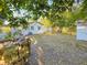An exterior view showcasing a large yard, mature landscaping, and white storage shed at 1318 Preston S St, St Petersburg, FL 33712