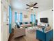Bright living room with neutral furniture, stylish accents, and a ceiling fan for added comfort at 1318 Preston S St, St Petersburg, FL 33712