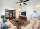Cozy living room with ample seating, a wooden bookshelf, and a sleek television on display at 1318 Preston S St, St Petersburg, FL 33712