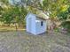 Exterior view showcasing the white storage shed with a chain link fence at 1318 Preston S St, St Petersburg, FL 33712